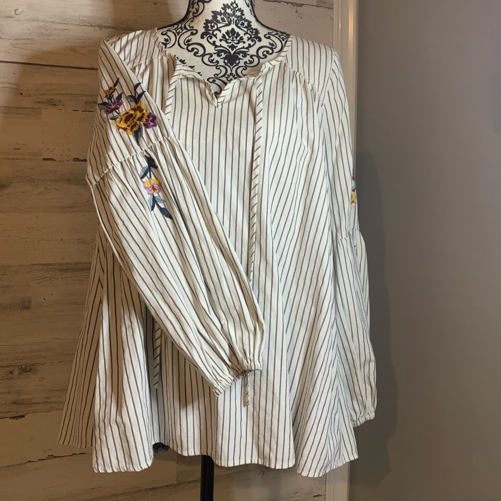 Women’s striped top with floral detail on sleeve